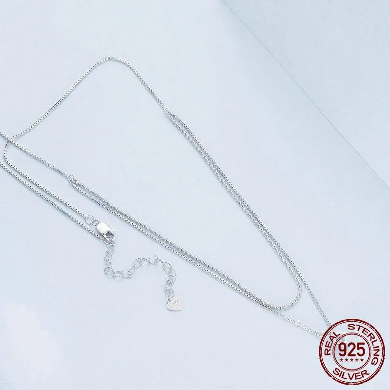 Women's double-layer sterling silver necklace with pearl chain detail in polished silver colour