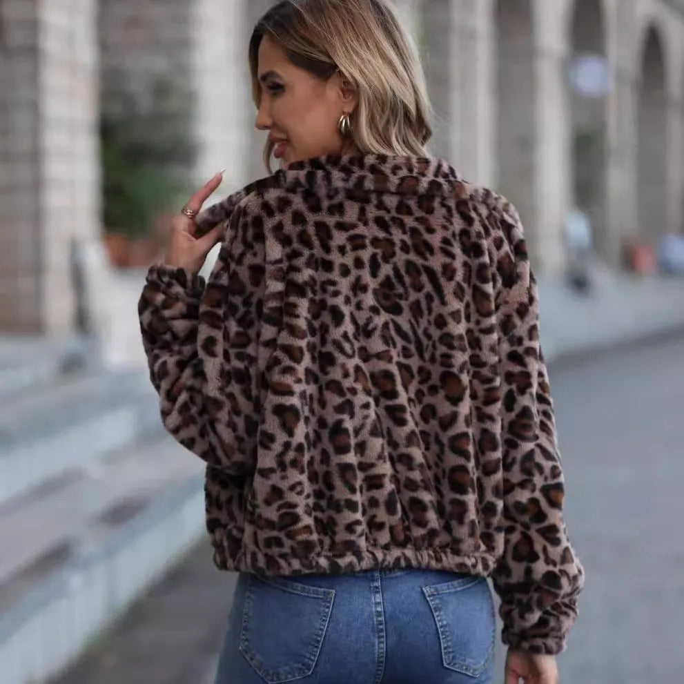 Women's loose leopard print plush coat with front zip and raglan sleeves on a hanger