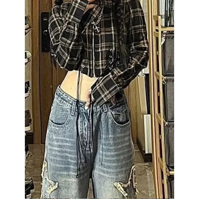 Blue high waist wide-leg denim trousers on a hanger, showing straight leg cut.