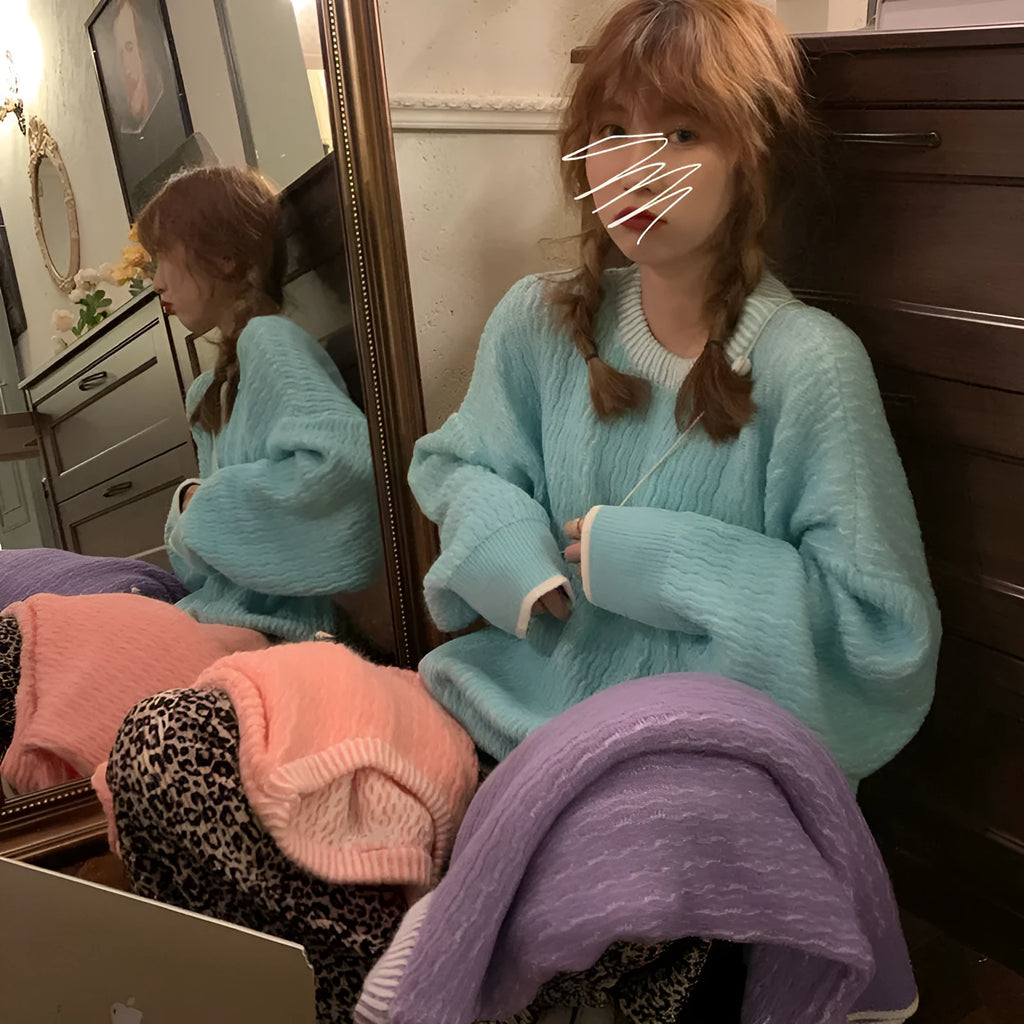 Women's loose blue pullover sweater with regular sleeves on a hanger