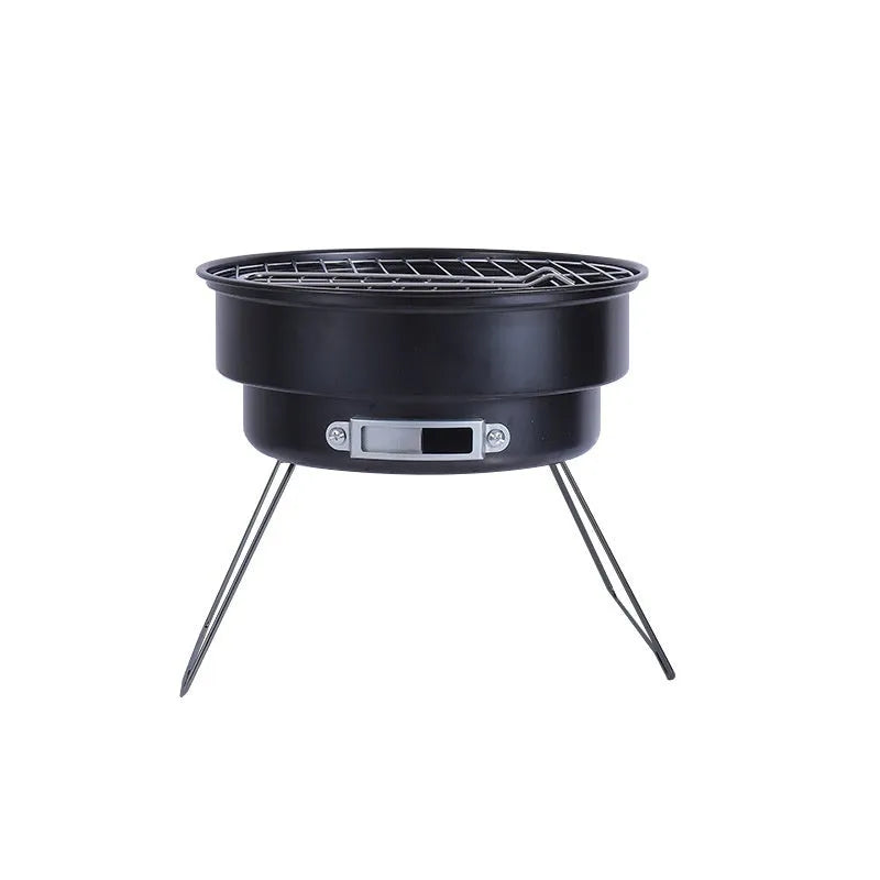 Small round metal folding camping stove with grill mesh and legs, packed in a carry bag.
