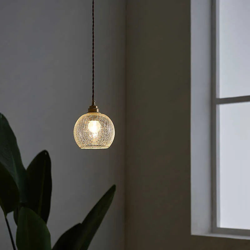 Retro-style brass and glass ball chandelier ceiling light with copper body and spherical shades.