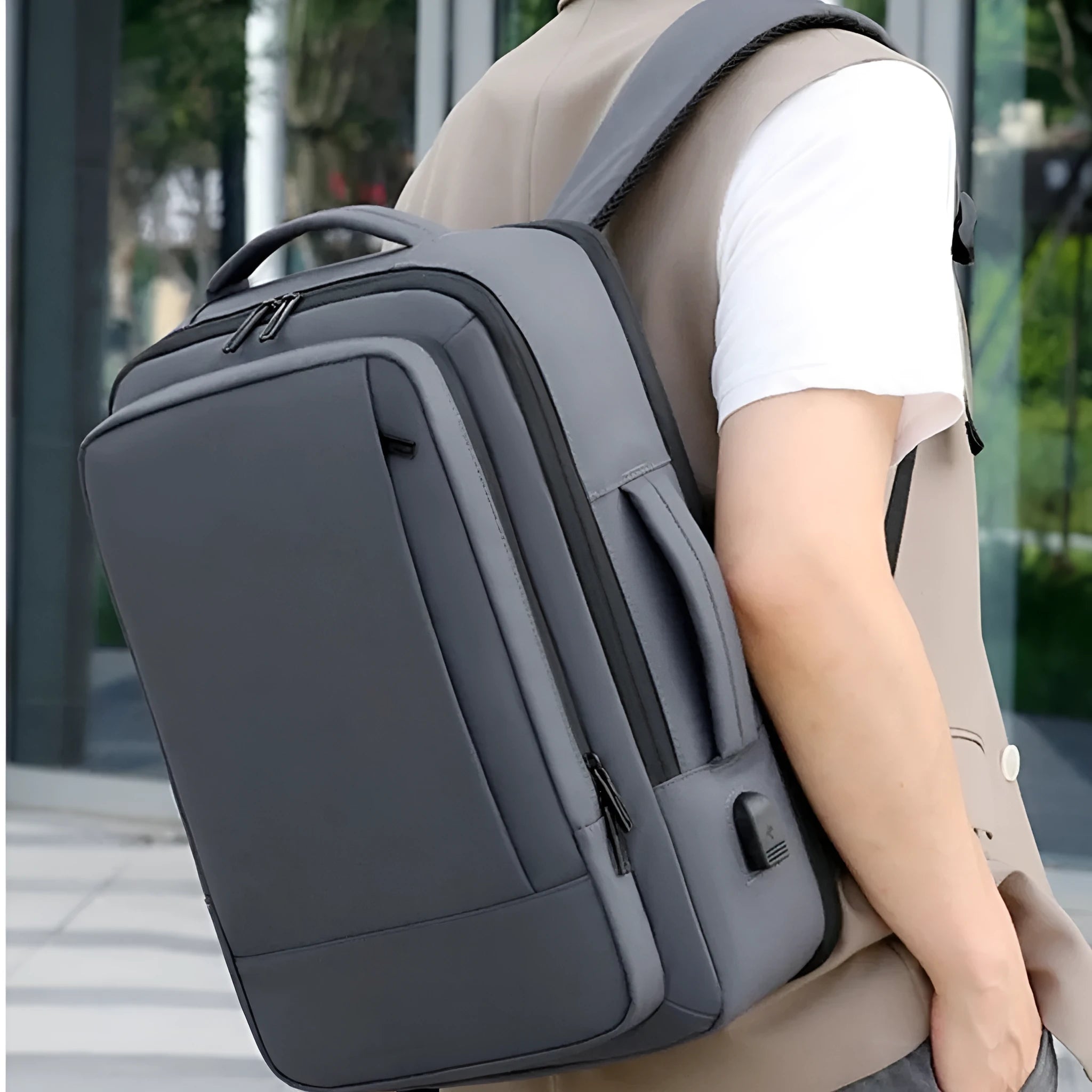 Black or grey waterproof oxford cloth backpack with curved shoulder straps showing 20-35 litre capacity
