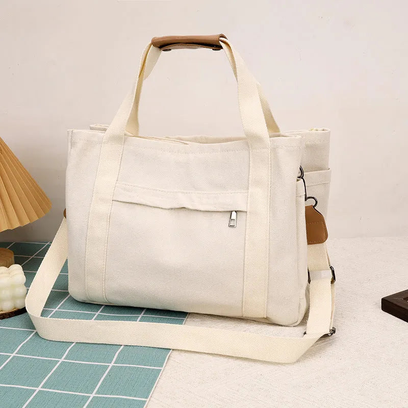 Large canvas tote bag with multiple internal compartments in horizontal square design