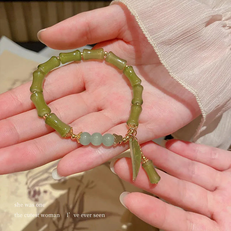 Chinese style glass bead bracelet with bamboo leaf design and manual craftsmanship details.