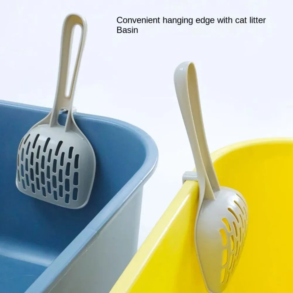 Grey plastic cat litter scoop with integrated base on a white background