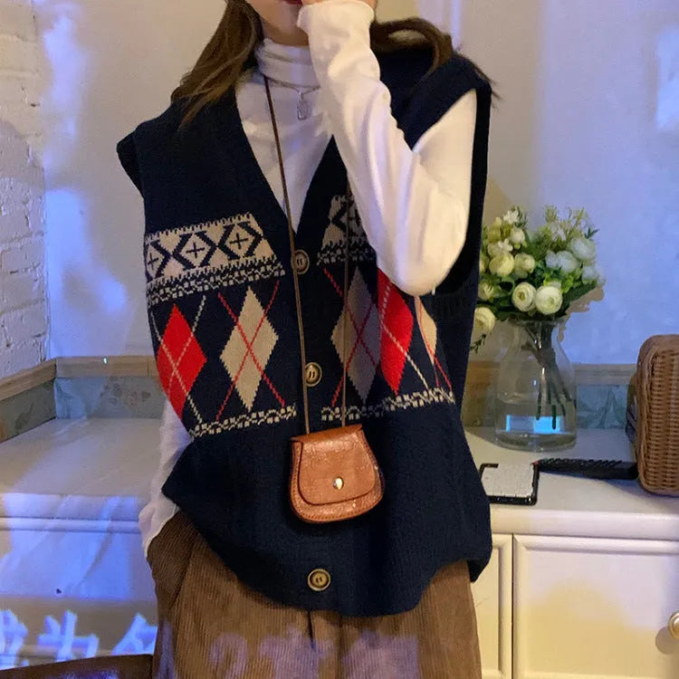Woman wearing a khaki sleeveless cardigan with a diamond plaid pattern, loose fit.
