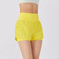 Women's loose cotton blend quick-drying sports shorts in lemon yellow on a mannequin