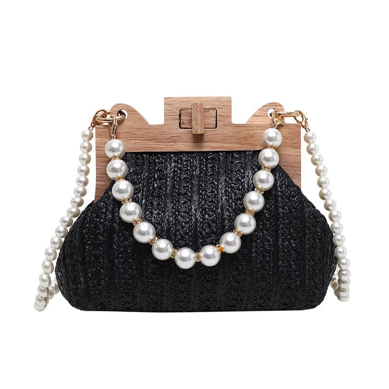 Women's woven straw shoulder bag with pearl chain details showing interior organisation compartments