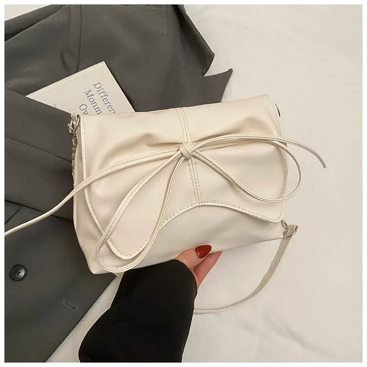 Women's black PU leather crossbody bag with large capacity and a front sandwich pocket.