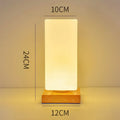 Nordic style solid wood USB table lamp in white, showing touch dimming and one of the geometric shape options.