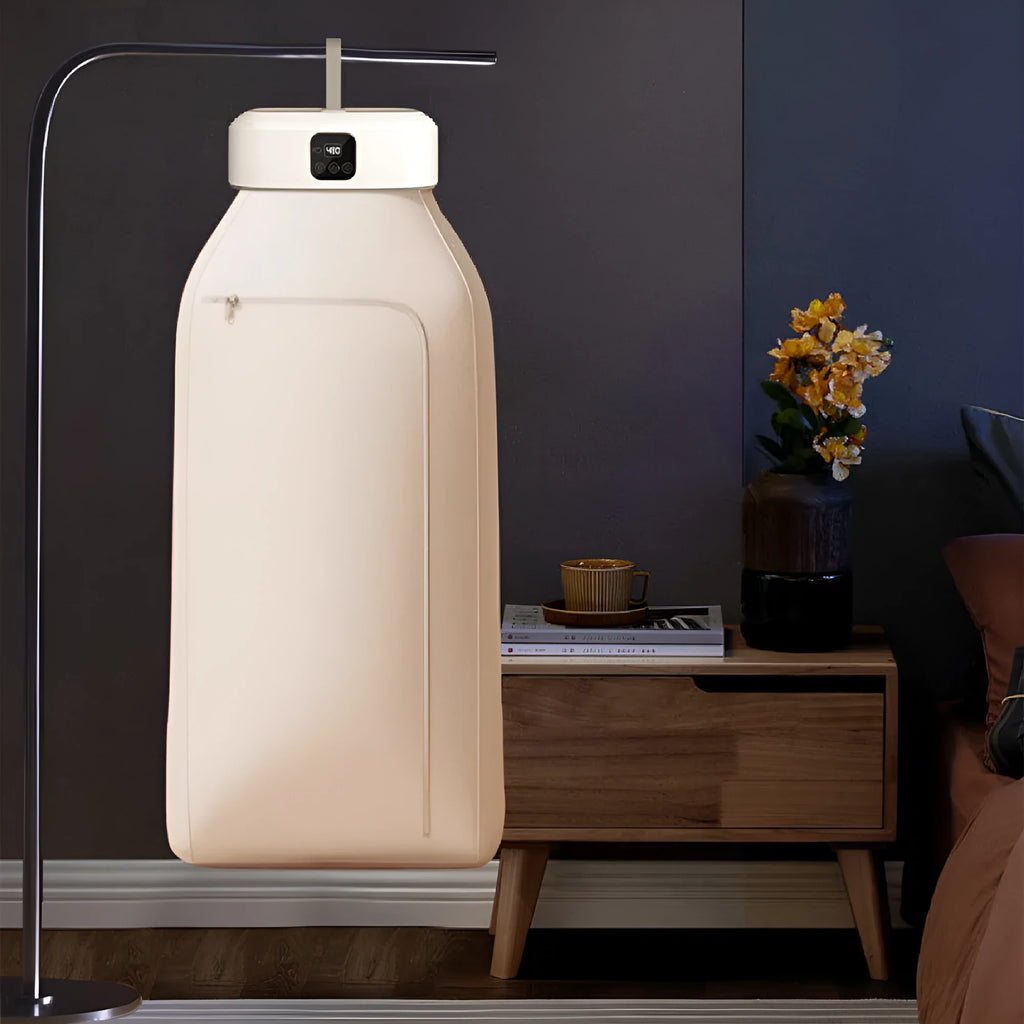 White cylindrical foldable electric clothes dryer with remote control, shown in open position