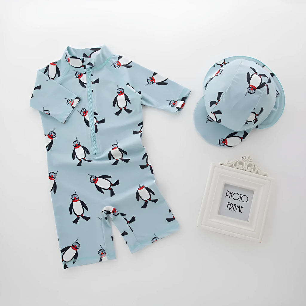 Boys' penguin print one-piece swimsuit with long sleeves and matching swimming cap for children aged 2-7 years