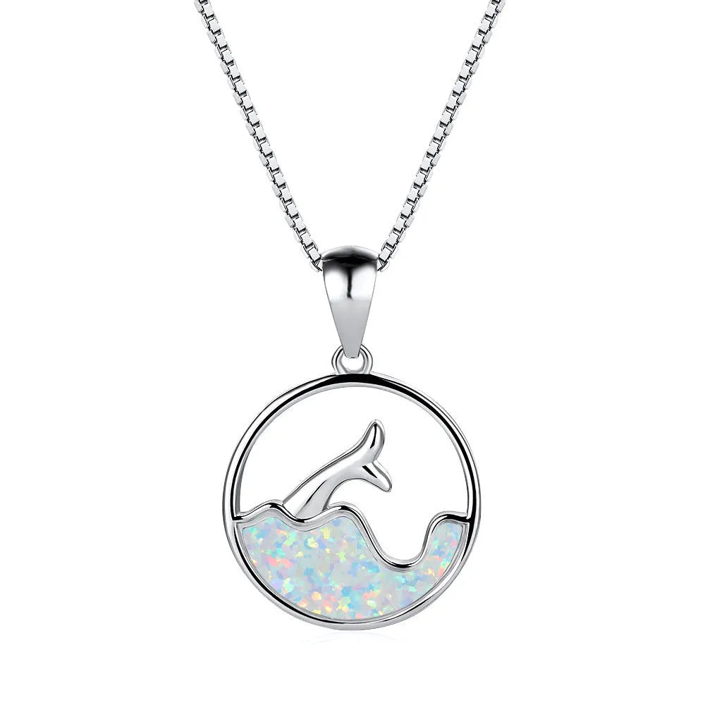 White gold electroplated sea fishtail necklace with a round blue opal pendant on a chain.