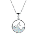 White gold electroplated sea fishtail necklace with a round blue opal pendant on a chain.
