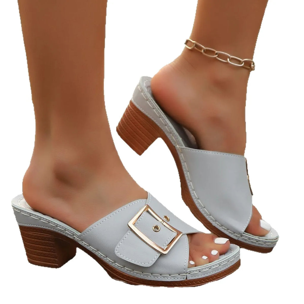 Women's black summer slippers with a chunky heel, round toe, and a silver metal buckle fastening.