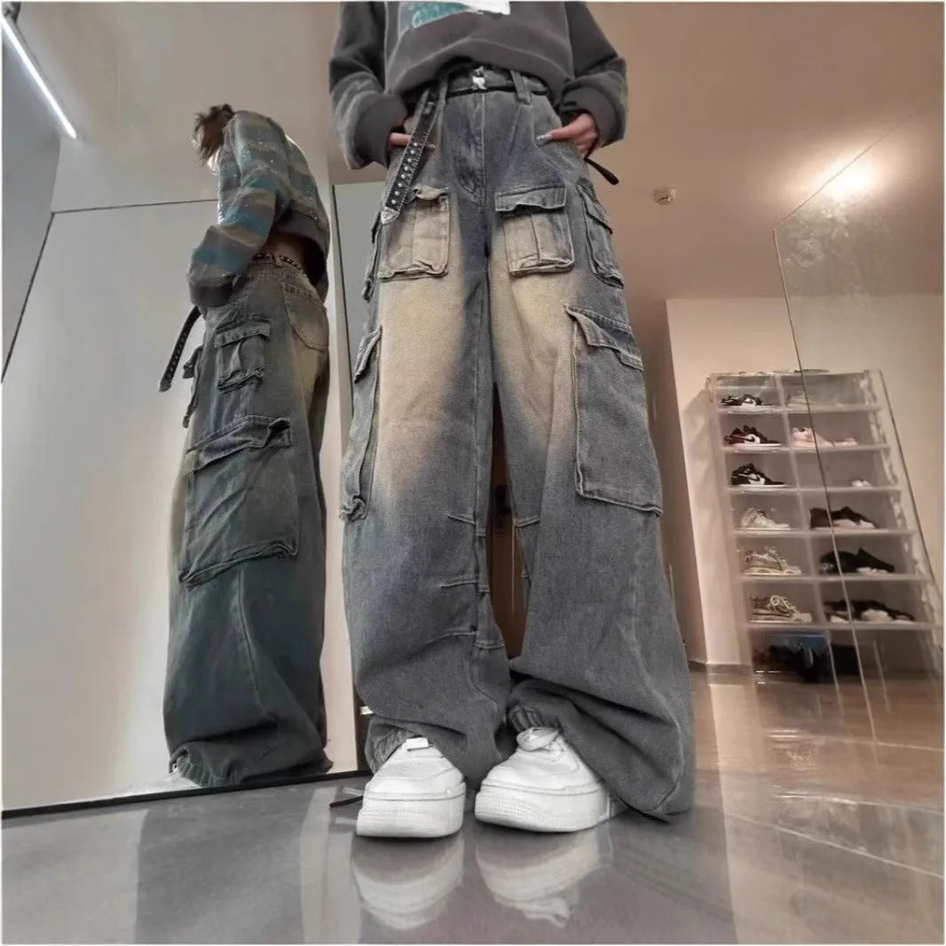 Men's light blue loose fit distressed jeans with multiple pockets on a straight leg.