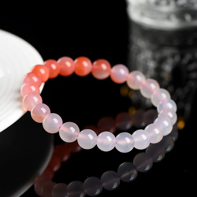 Natural gradient Yanyuan agate bracelet with geometric polished beads on a wrist, showing salt source colour variation.