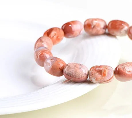 Natural cherry blossom coloured agate barrel bead bracelet with a Ruyi charm.