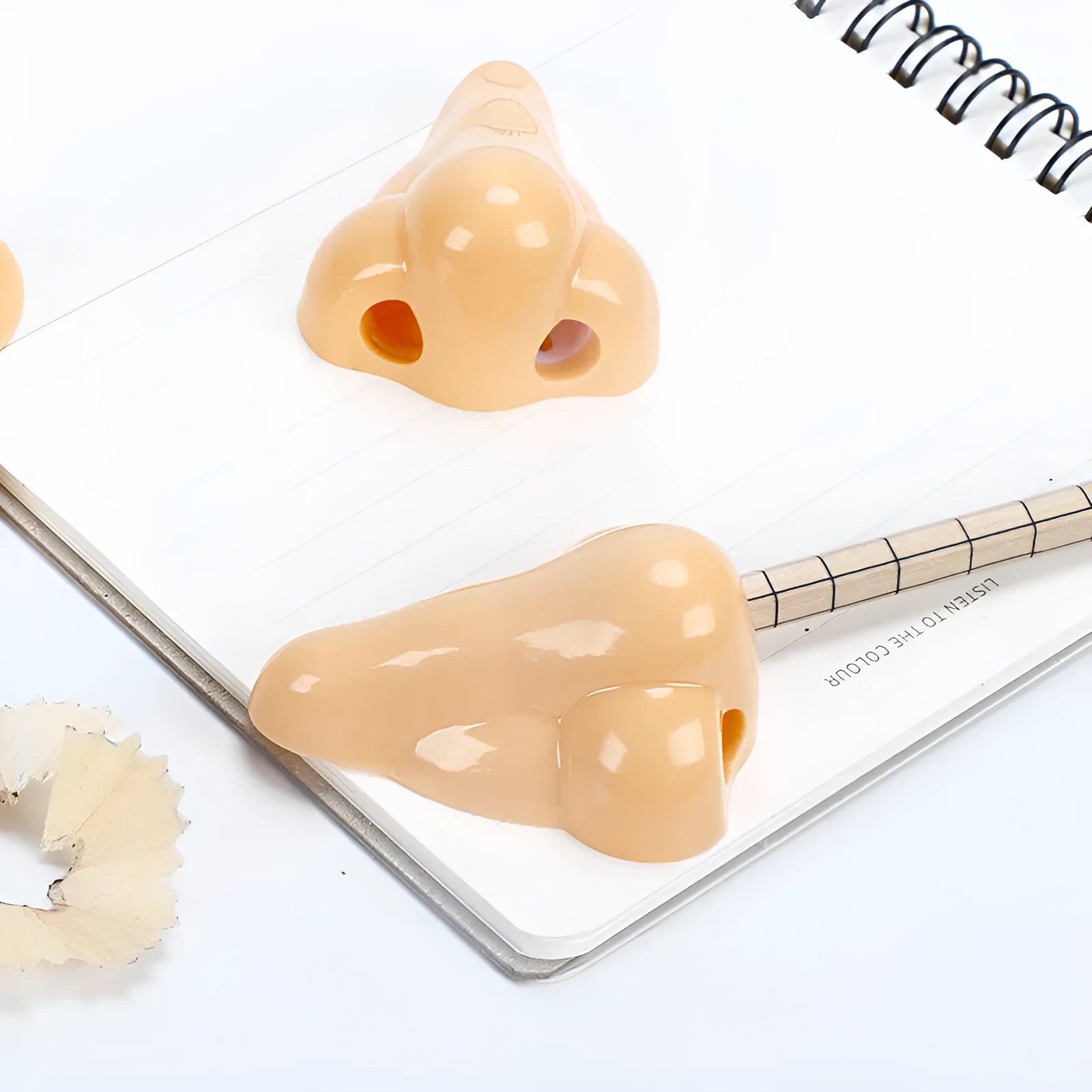 Flesh colour plastic pencil sharpener showing geometry shape and big nostril opening