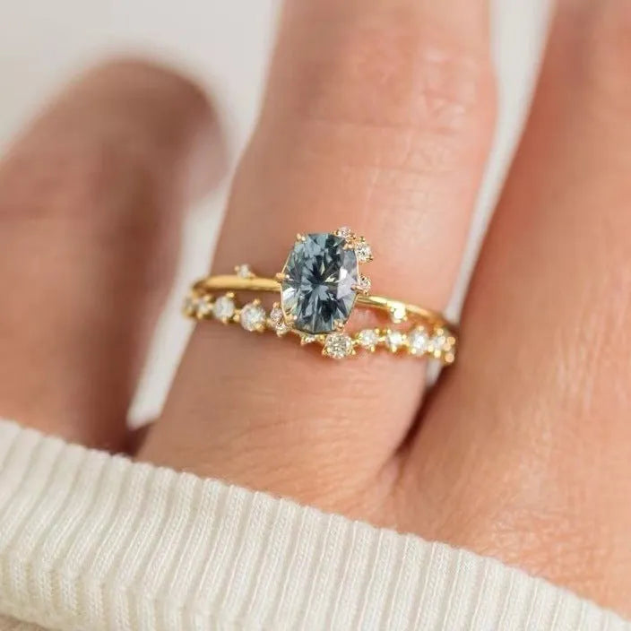 Gold plated women's ring with green zircon stone in flower shape setting, showing front and side views
