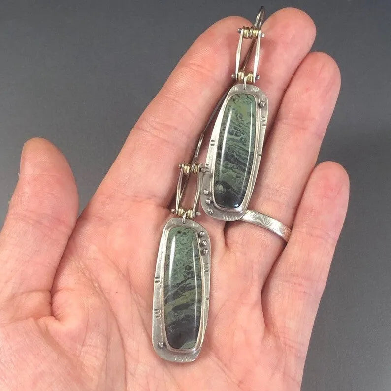 Geometric two-colour marble pattern alloy earrings on a white background.