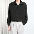 Men's loose non-iron polyester shirt in black and white, front view, with casual styling