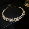 Geometric curved alloy necklace in silver finish, shown as a clavicle chain.