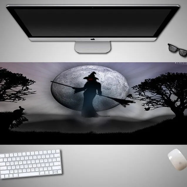 Oversized Halloween-themed rubber cloth mouse pad on a desk, showing non-slip base and large surface area.