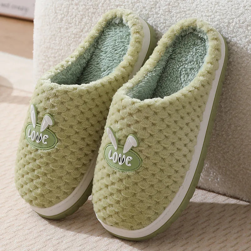 Women's rabbit and plaid print artificial fur slippers with thick rubber sole.