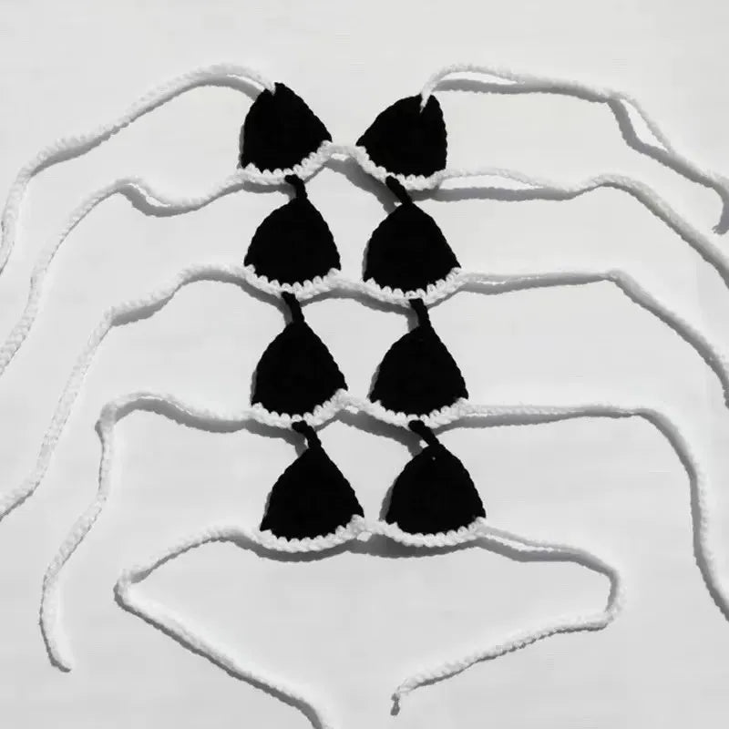 Cat wearing black bikini costume with matching bra for Halloween party