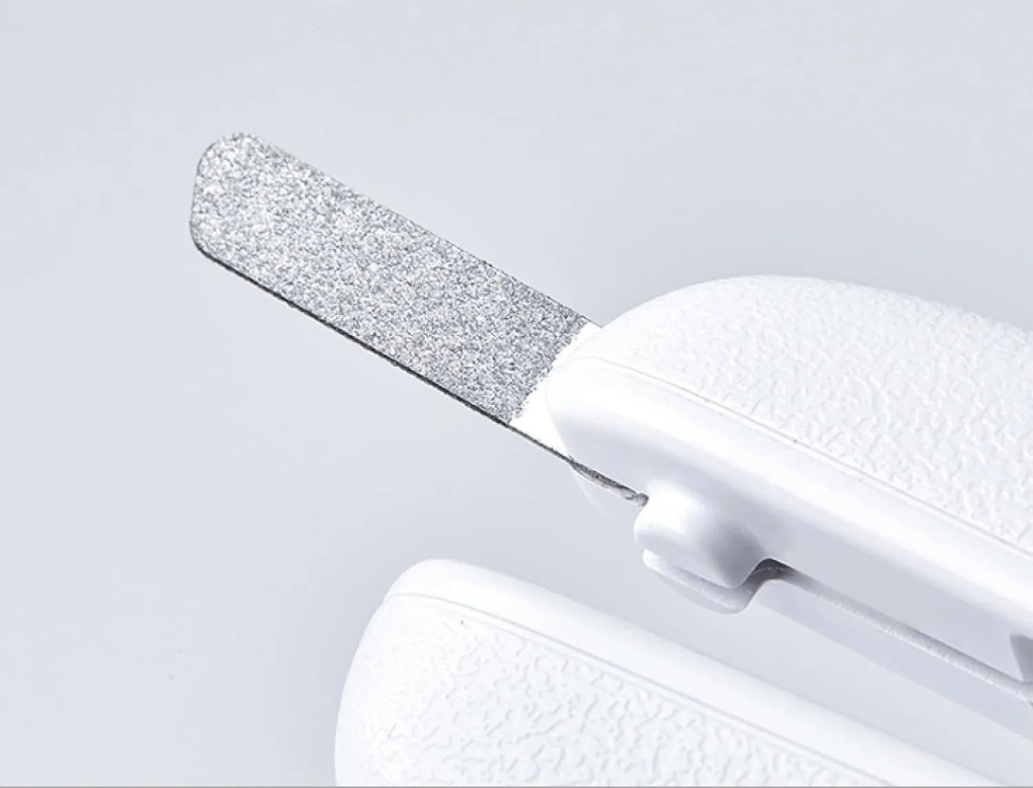 White pet nail clippers with built-in LED light and transparent anti-splash guard.