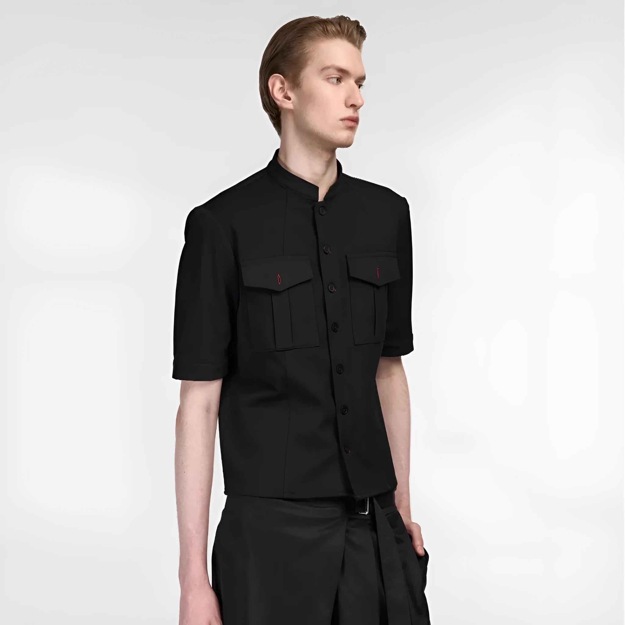 Handmade black half-sleeve hunting shirt with shirt collar on a hanger.