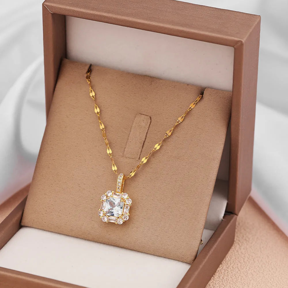 Gold geometric quadrilateral pendant necklace with mixed gemstones on a water wave chain.