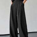 Black men's casual trousers with vertical stripes, front pleats, and an elasticated waistband.