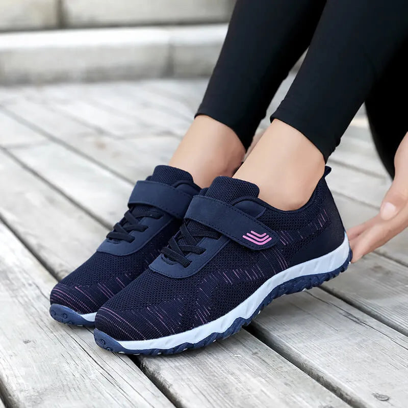 Women's grey purple low-top wedge heel shoes with mesh upper and Velcro strap fastening.