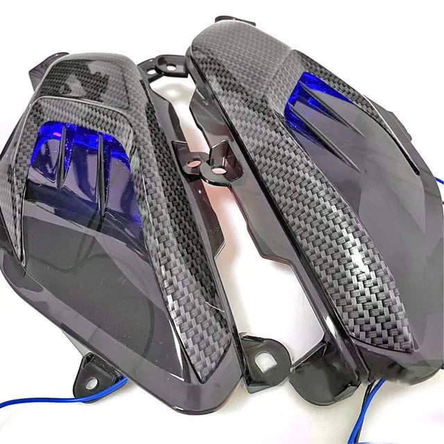 Yamaha NMAX scooter side lamp LED replacement kit with carbon fibre decoration showing blue and red light options
