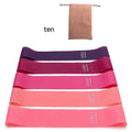 Set of five coloured TPE yoga tension straps for fitness training laid flat showing green, blue, yellow, red, and black.