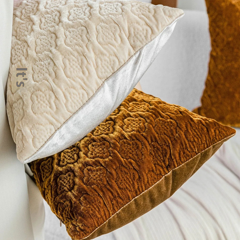 Brown gold antique-style quilted square cushion pillow and matching lumbar pillow on a sofa.