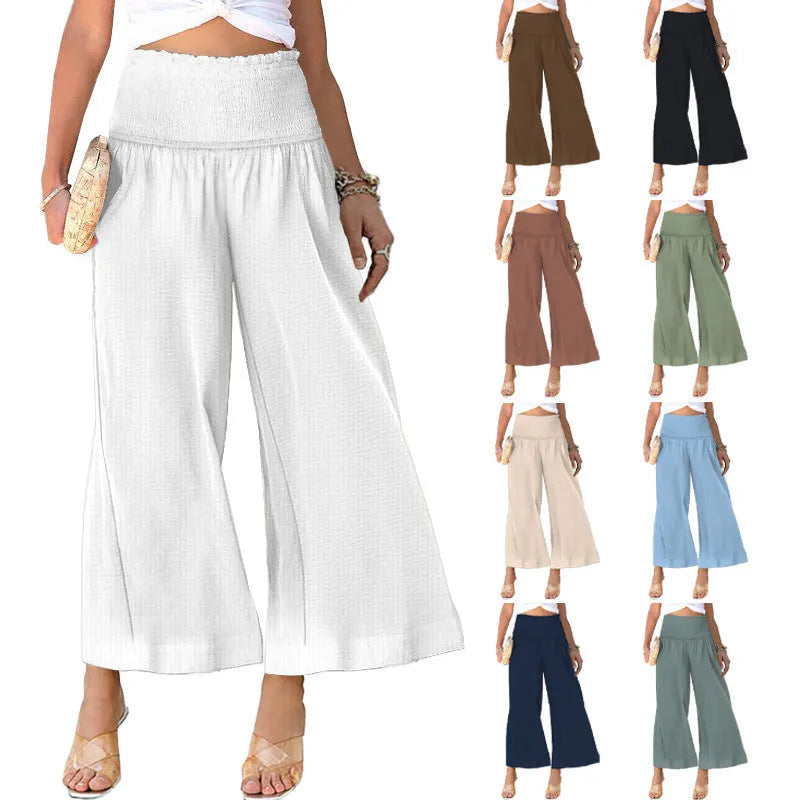 Woman wearing high-waist pleated casual trousers in a cotton-linen blend, showcasing the cropped straight-leg style.