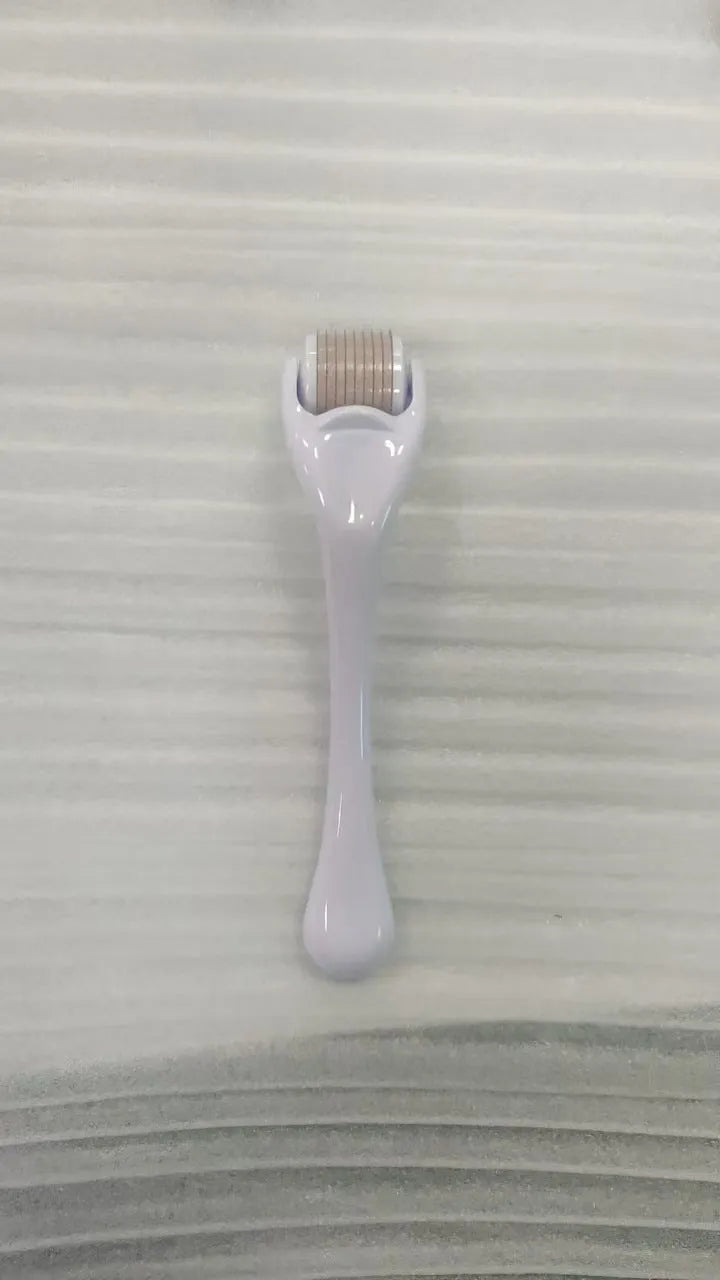 Black handle microneedle roller with purple wheel showing 540 needles, next to white and blue handle options.