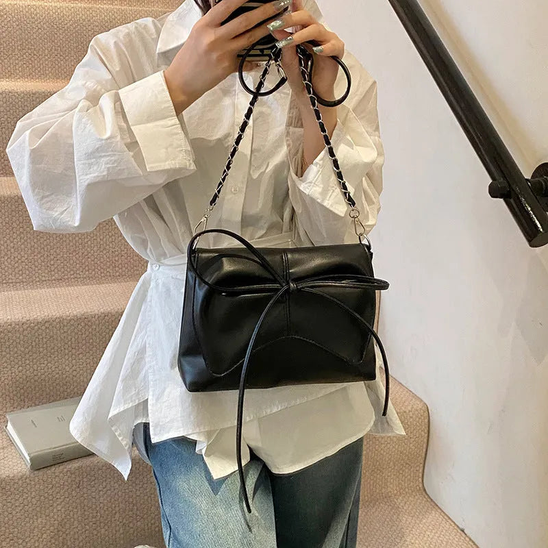 Women's black PU leather crossbody bag with large capacity and a front sandwich pocket.