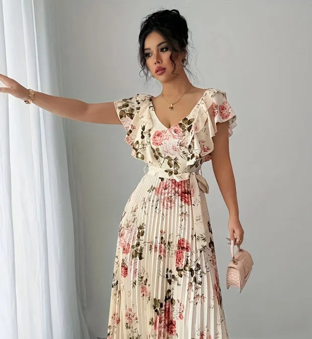 Apricot coloured floral print dress with a v-neck, ruffled short sleeves, and a long high-waisted swing skirt.