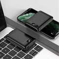 Black or white portable power bank with dual USB ports showing 10000mAh capacity