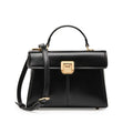 Women's black leather shoulder bag with vachette clasp showing organised interior compartments