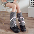 Plush leg warmer in solid colour with decorative bow, autumn winter design for women