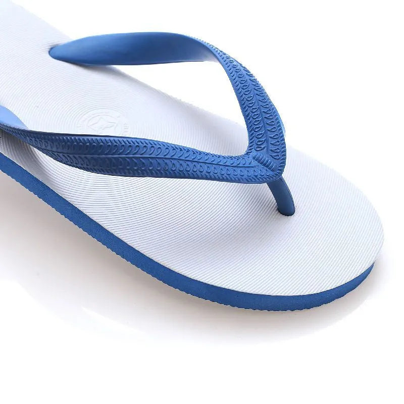 A pair of rubber flip-flops with a fish label on the strap, showcasing a non-slip patterned sole.