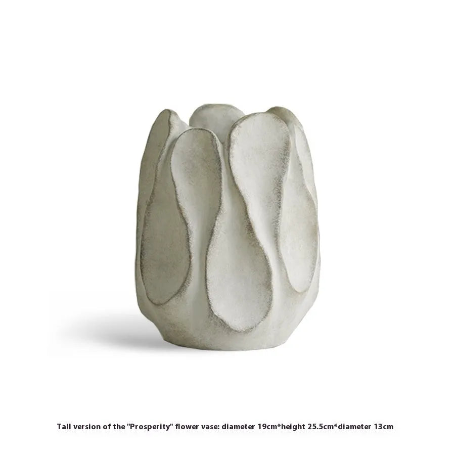 Irregularly shaped art ceramic vase in a low style profile on a wooden surface