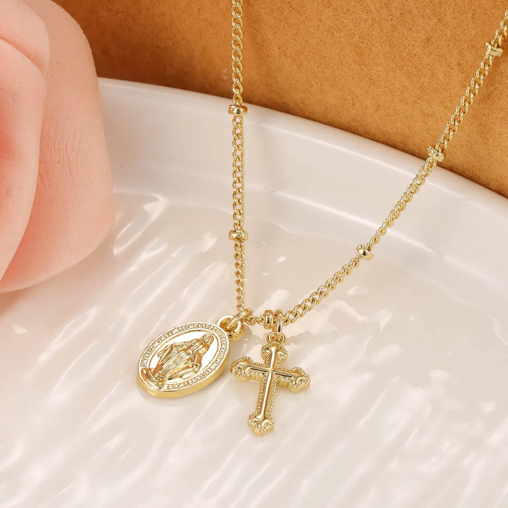 Gold Virgin Mary cross necklace with geometric design on chain