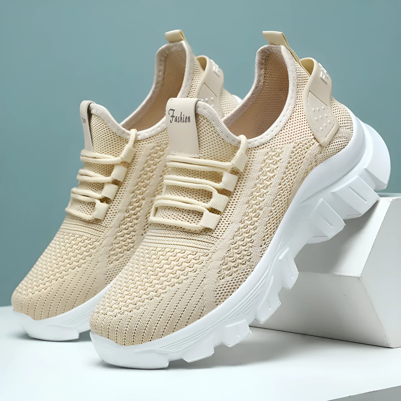 Women's white Flyknit lace-up sneakers with a thick PVC sole and round toe on a neutral background